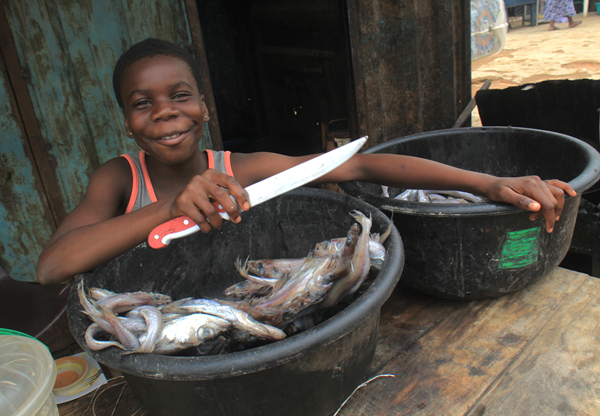 After completing her primary education, Promise is waiting for her mother to determine the next step. For now, she helps her mother who sells fried fish.