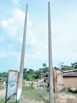 Two concrete electricity poles meant for installation of a transformer in Odowo community