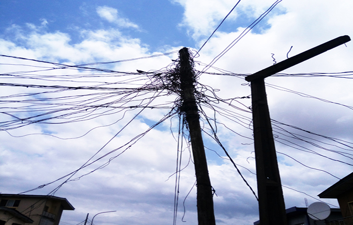 Damaged pole and clumsy cable at Unity Street, Off Toyin Street, Ikeja, Septer 16 2017.